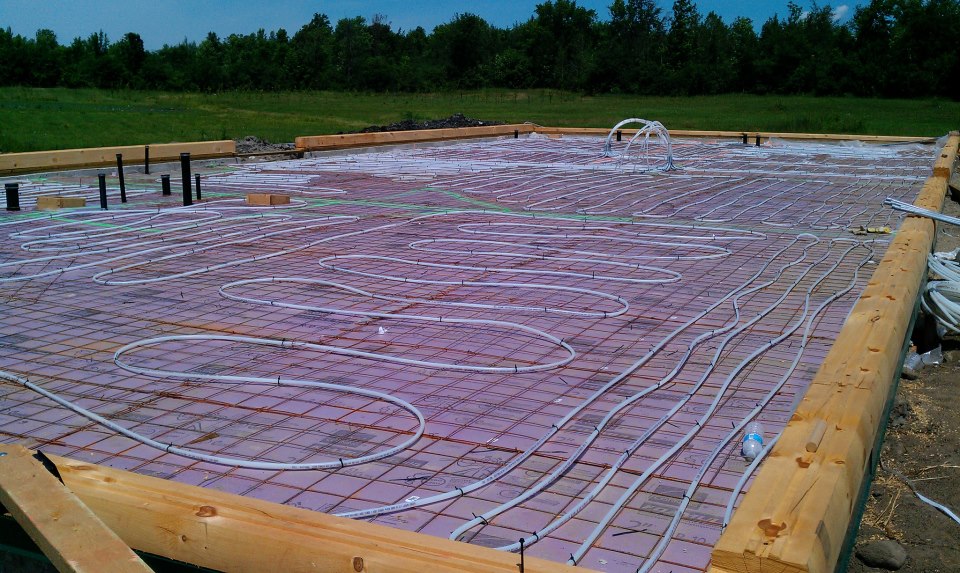 Radient floor heat installed prior to concrete slab for this custom log home in Ontario, Canada