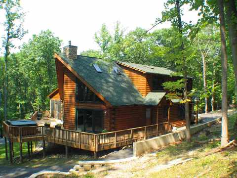 Custom designed log home using 8″ x 6″ logs and log siding.