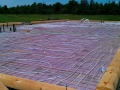 Radient floor heat installed prior to concrete slab for this custom log home in Ontario, Canada